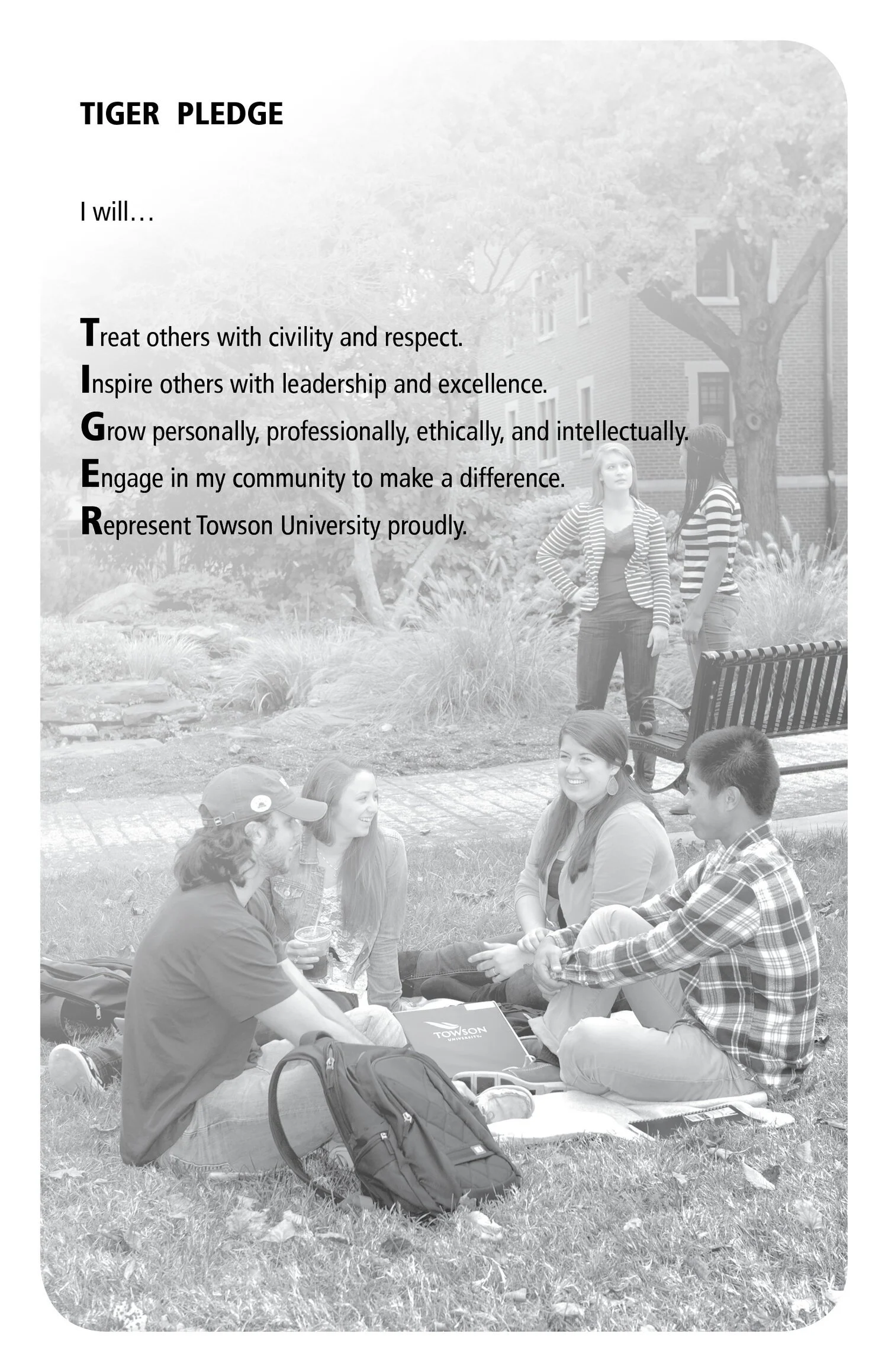 A black and white photo of a group of students sitting on the grass in a park, engaging in conversation and smiling. There are more students standing and talking in the background near a bench and trees. The image includes a Talon Pride pledge text o
