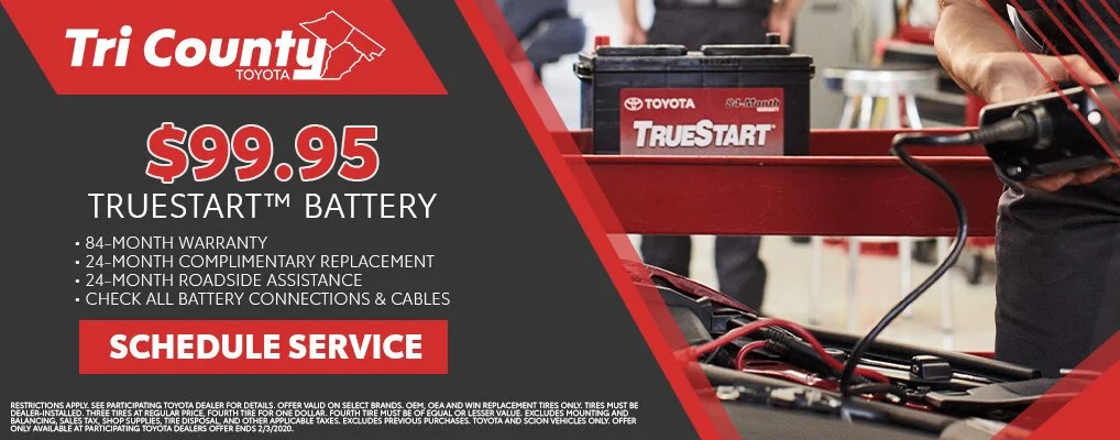 A promotional advertisement from Tri County Toyota for a $99.95 TrueStart car battery, featuring warranty, replacement, roadside assistance, and service scheduling details.
