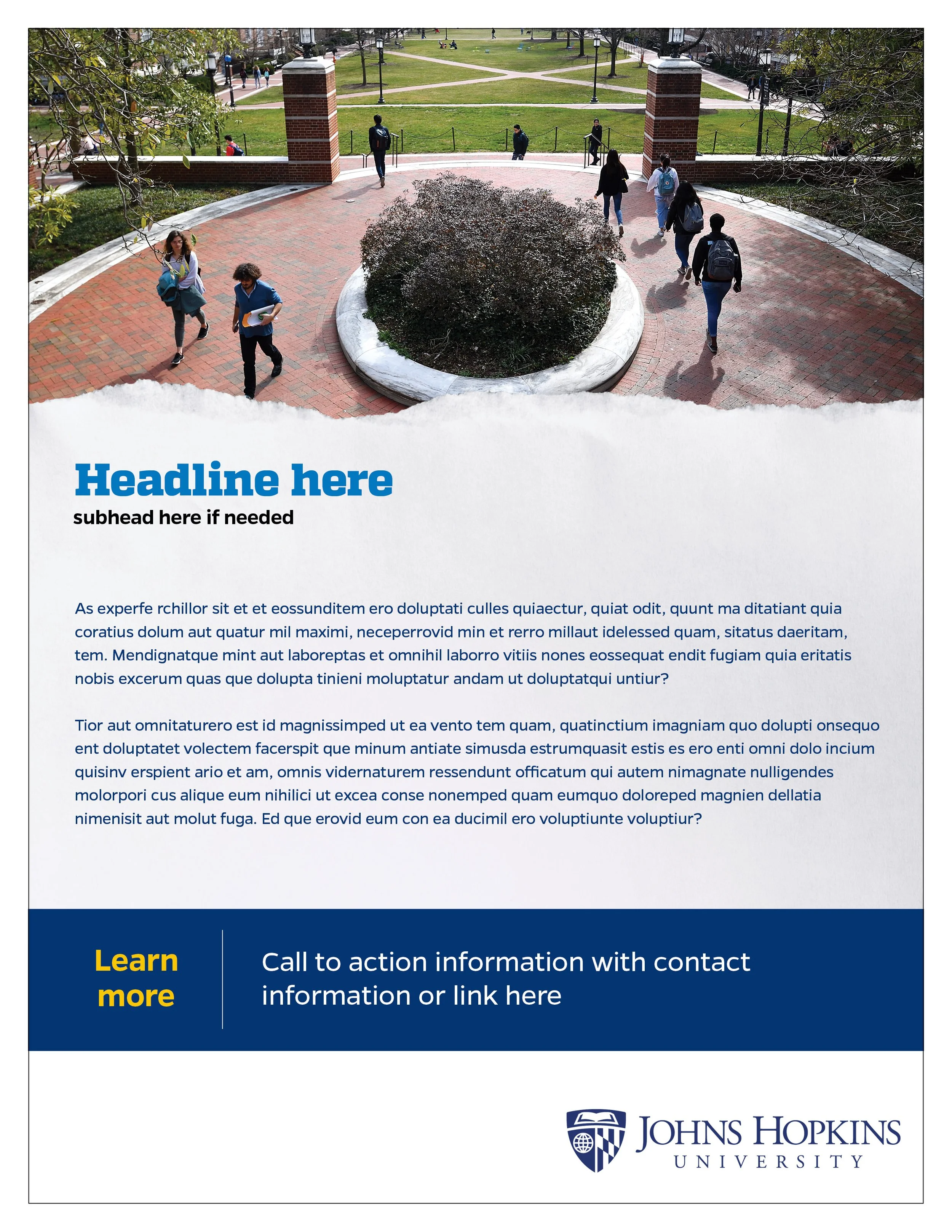 A group of students walking on a college campus pathway with a large bush and brick pillars at the entrance, green lawns, and additional students in the background.