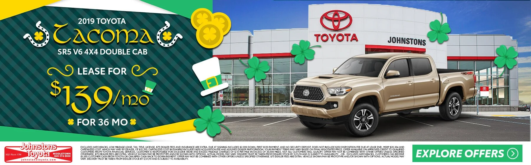 Advertisement for 2019 Toyota Tacoma, lease offer of $139/month for 36 months, dealership building with Toyota sign, and parked beige Toyota Tacoma truck with shamrocks and leprechaun hat decorations.
