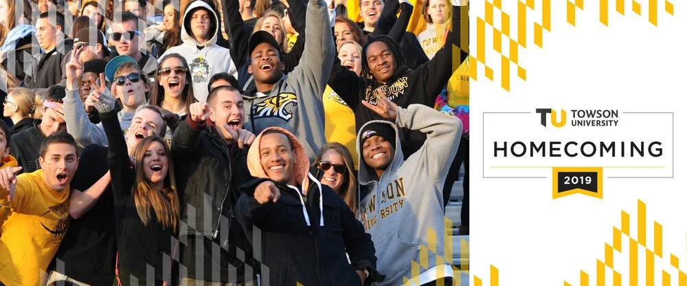 A group of diverse students celebrating at Towson University Homecoming 2019, smiling and cheering in a crowd.