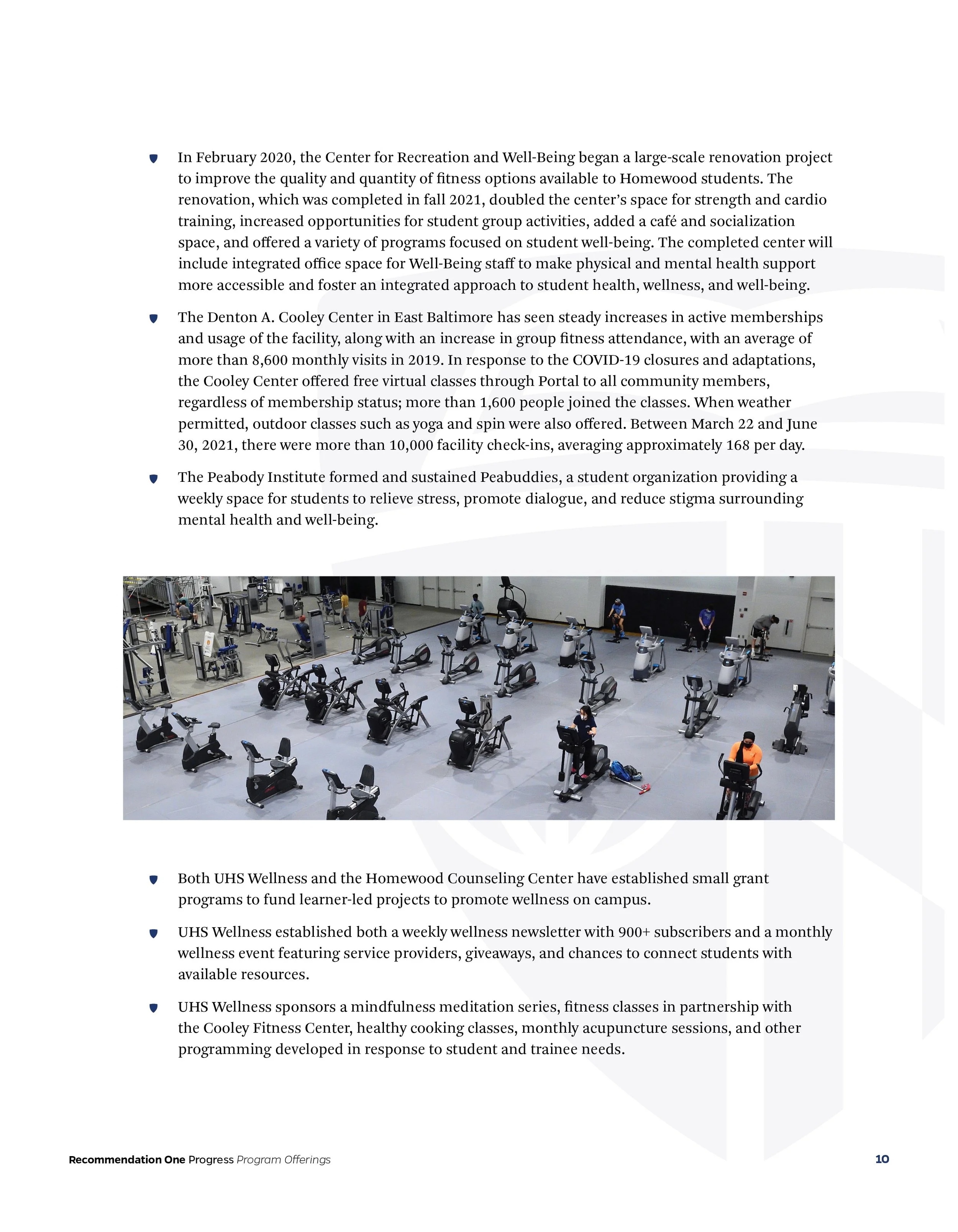 Page from a report with text about wellness initiatives and a photo of a gym filled with exercise equipment and people working out.