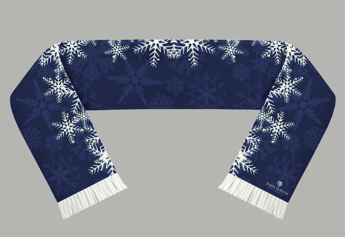 Blue winter scarf with white snowflake patterns and fringe, featuring John Hopkins University logo.