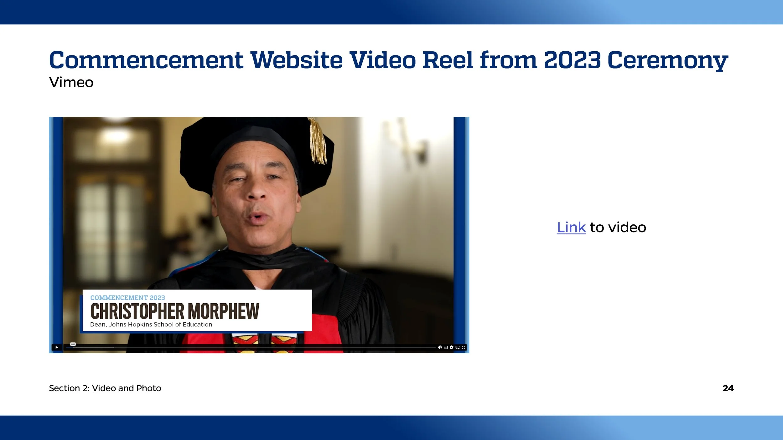 Screenshot of a presentation slide titled 'Commencement Website Video Reel from 2023 Ceremony'. It features a still image of a man in academic regalia, including a black cap with a gold tassel and a gown with a Superman logo. The caption on the image