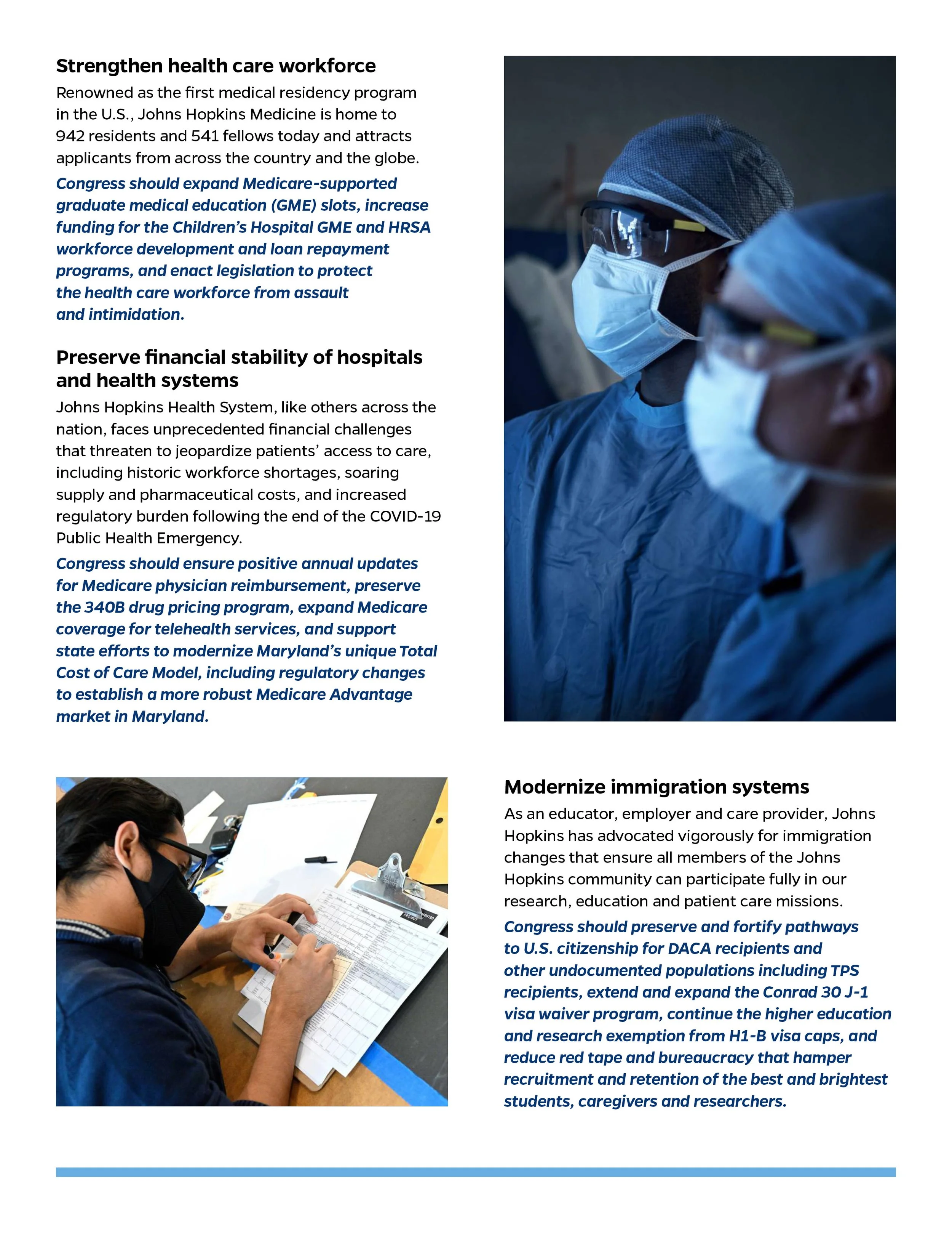 Two healthcare workers wearing masks and protective gear, standing indoors.