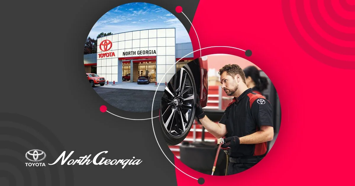 A Toyota dealership building labeled North Georgia in the background, and a mechanic inspecting a car wheel in a garage in the foreground.
