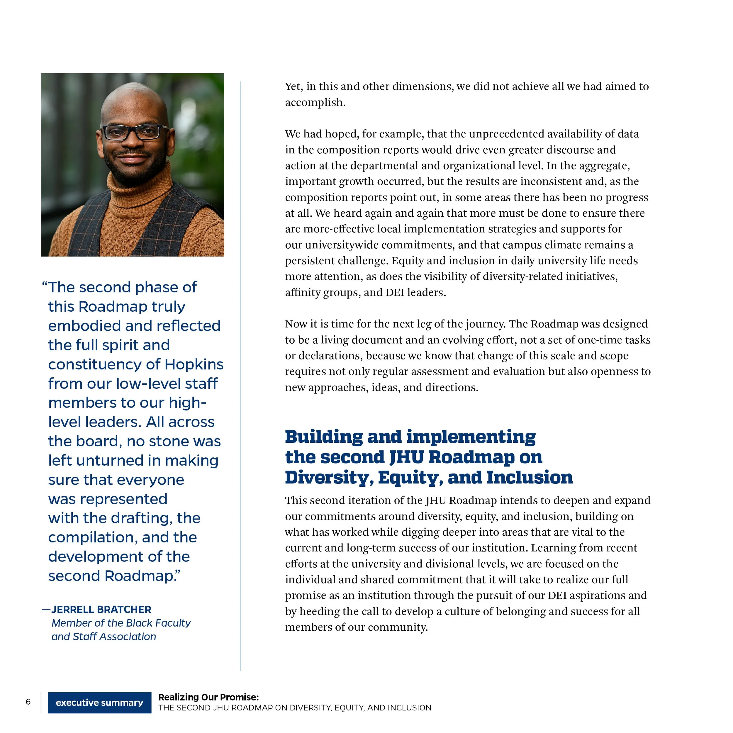 A man in glasses, wearing a brown sweater and checkered vest, standing outdoors with trees in the background.