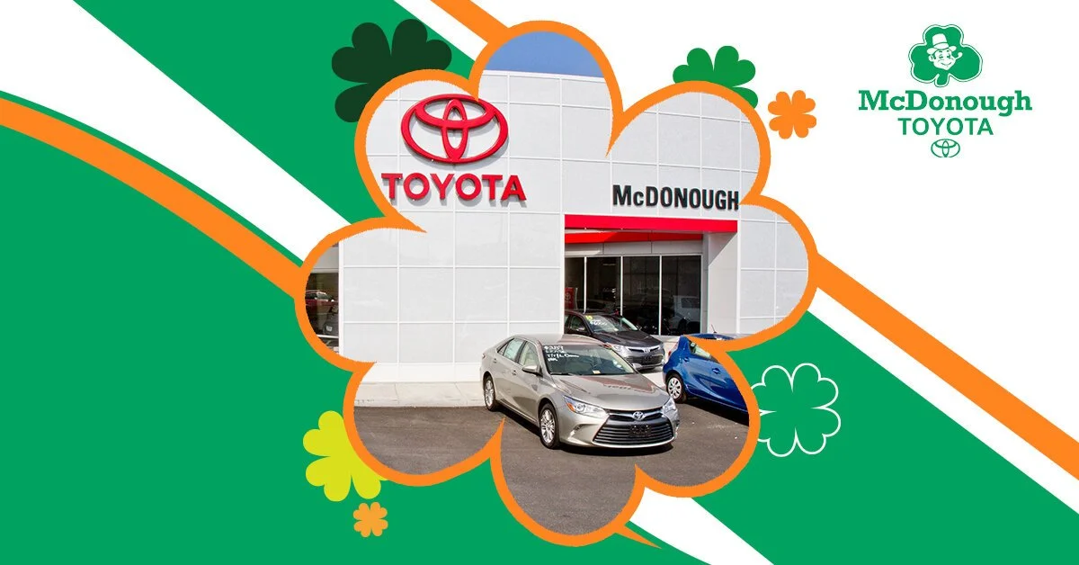 Exterior of a Toyota car dealership with cars parked outside, and a sign for McDonough Toyota.