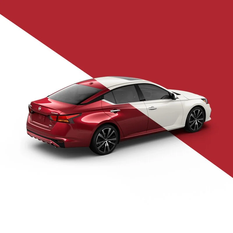A modern Nissan Altima sedan with a two-tone paint job, half red and half white, on a diagonally split background matching the car's colors.