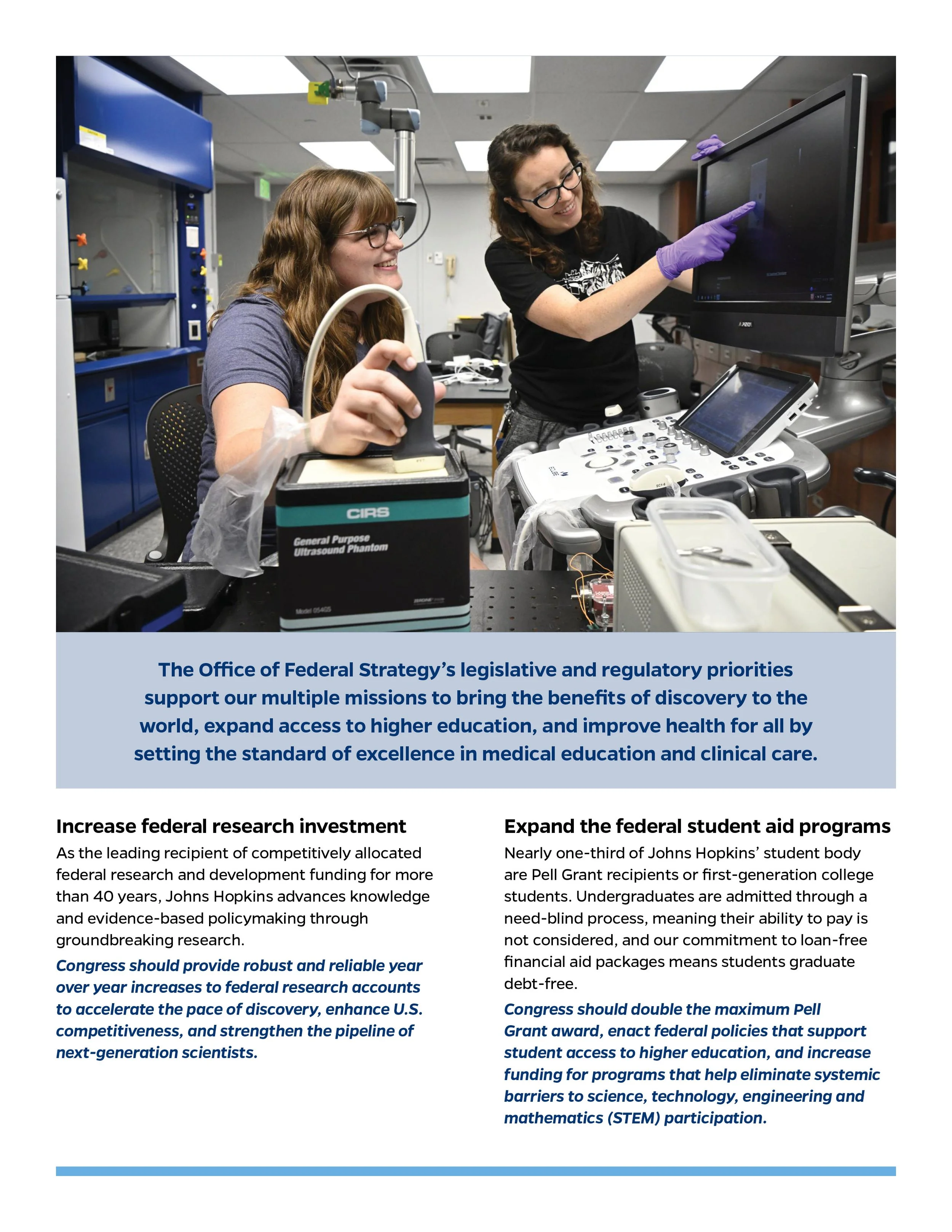Two women working in a medical research lab, one showing a screen to the other.