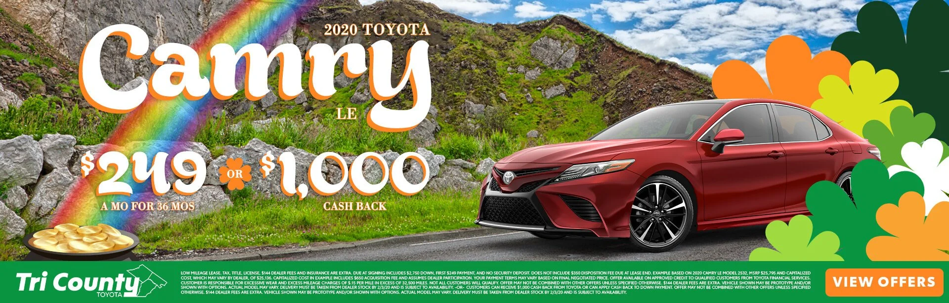 A promotional advertisement for a 2020 Toyota Camry with a background of mountains, grass, and a rainbow. The image features a red Toyota Camry parked on the side of a road surrounded by colorful flowers, with large white and orange text advertising 