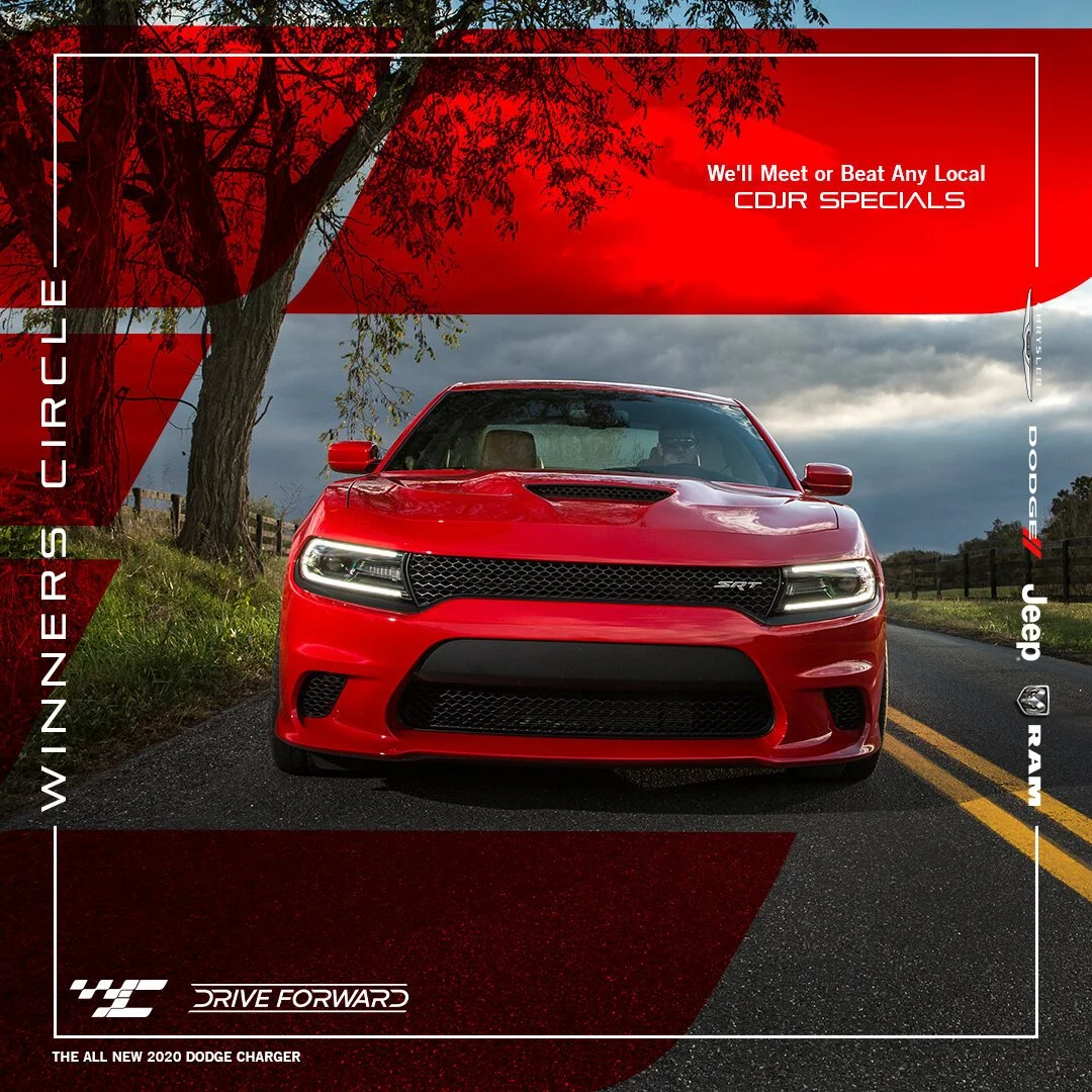 Red 2020 Dodge Charger on a rural road with dark clouds, surrounded by trees and grass.