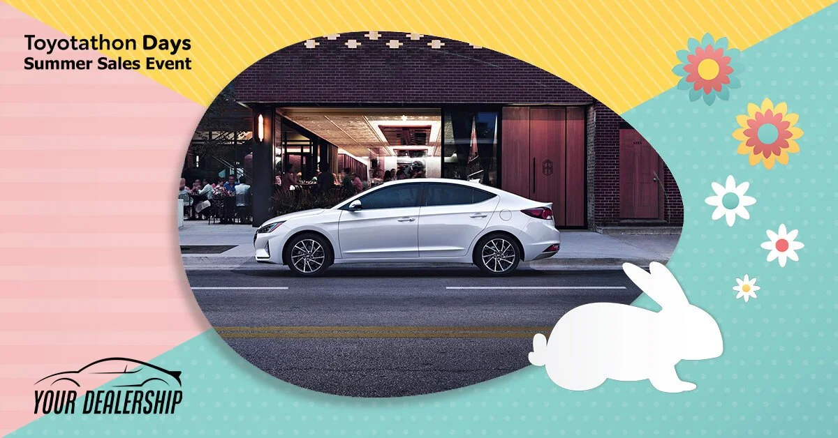 A white sedan car parked on the street in front of a restaurant with outdoor seating.