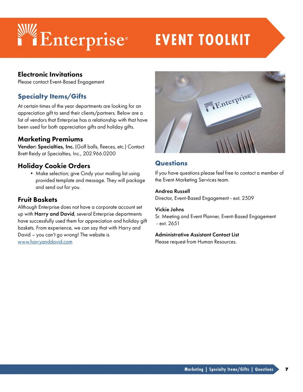 A table setting with a box labeled 'Enterprise' on a place mat, with a knife, fork, and wine glasses nearby.