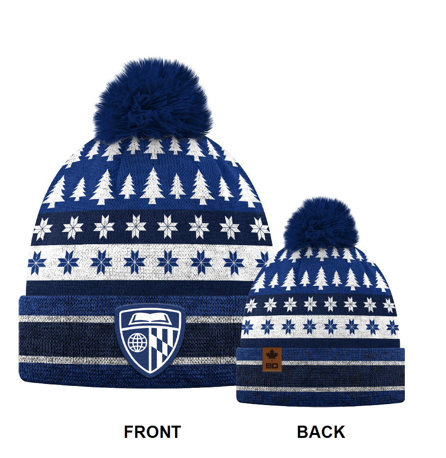 Pair of blue and white winter knit beanies with pom-poms, featuring Christmas tree and snowflake patterns, one with an athletic shield logo and the other with a leather patch.