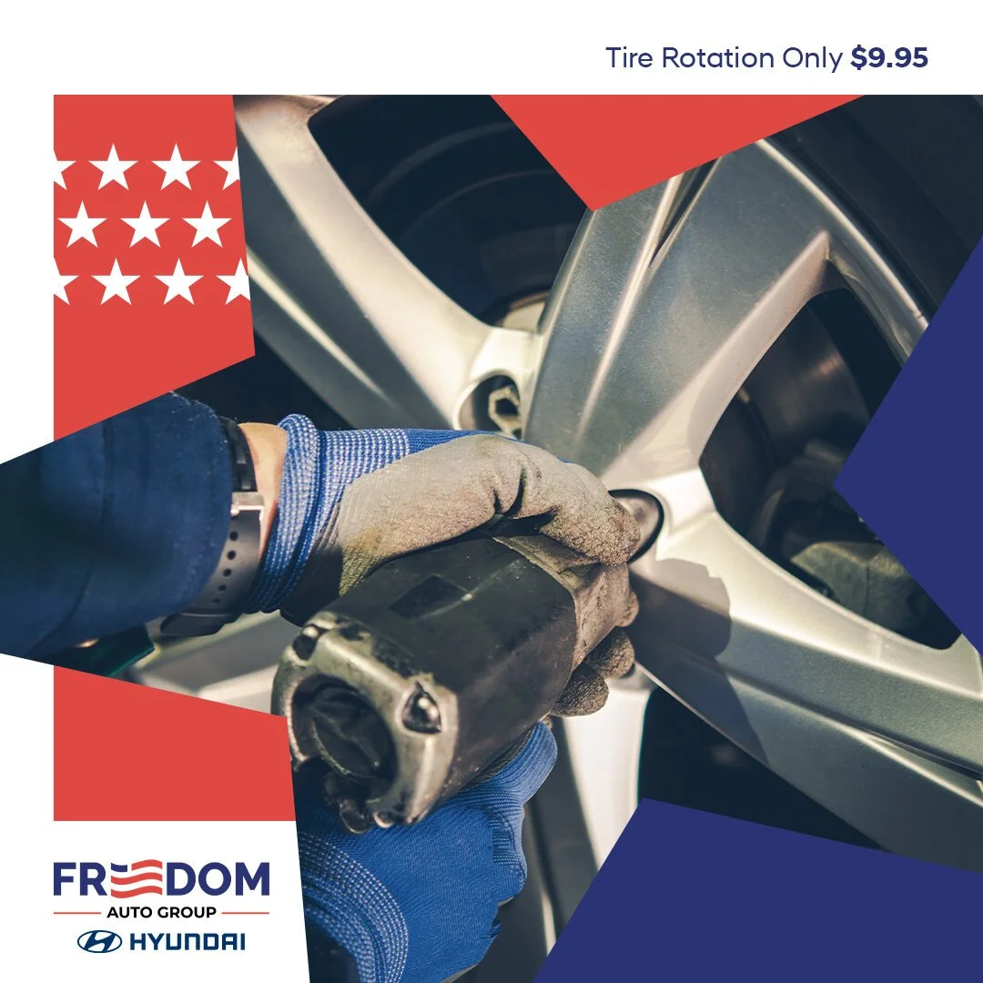 Person wearing a glove using a power tool to repair or replace a car tire.