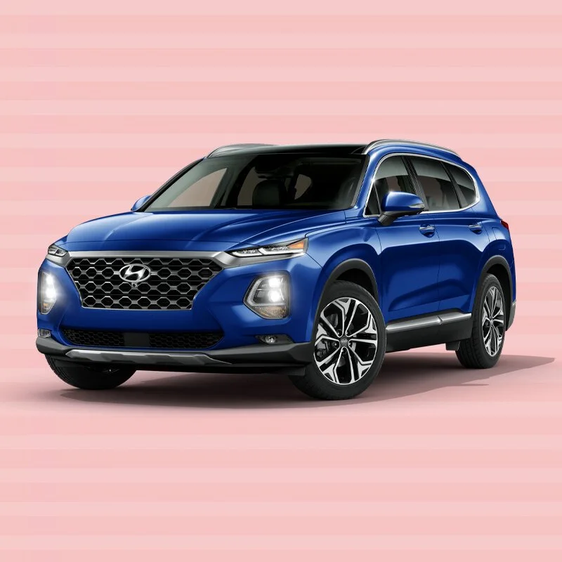A blue Hyundai SUV parked on a pink background with horizontal stripes.