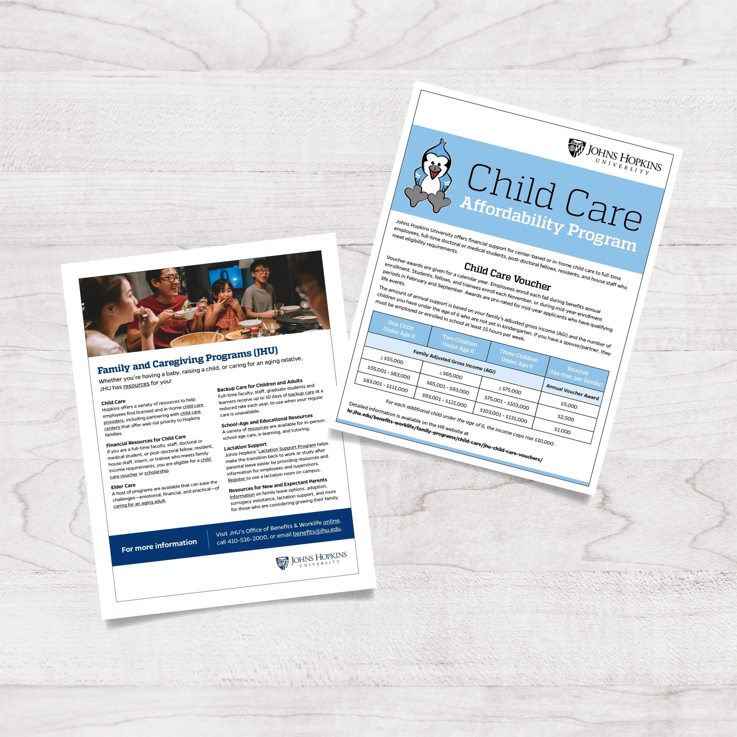 Flyers on a light-colored wooden surface about child care affordability programs from Johns Hopkins University, including information on family programs, child care vouchers, and resources for parents, with one flyer showing a group of children and a