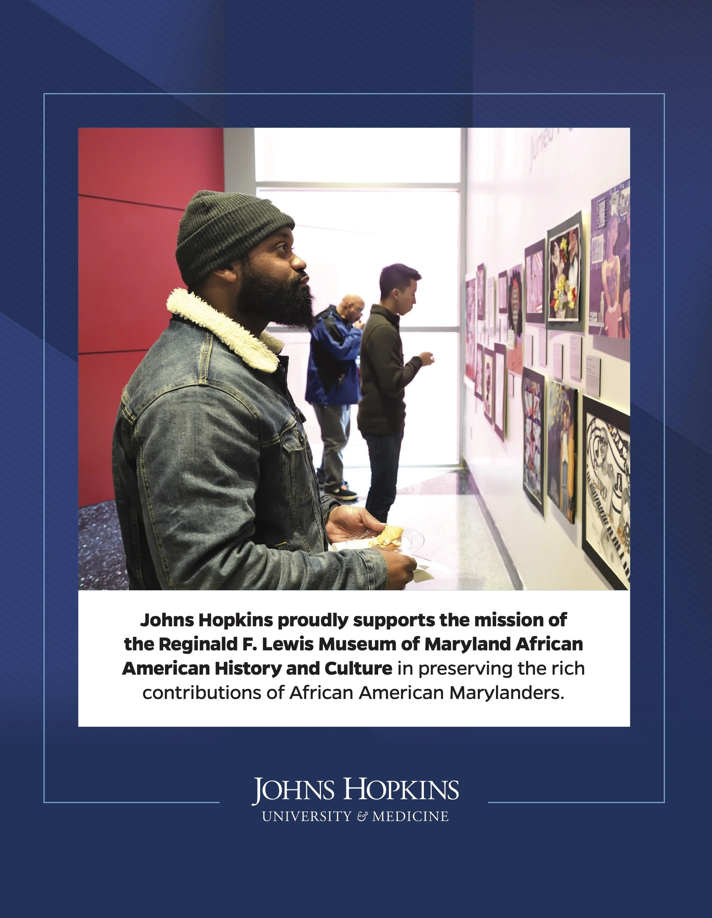 People viewing artwork at an exhibit in a museum