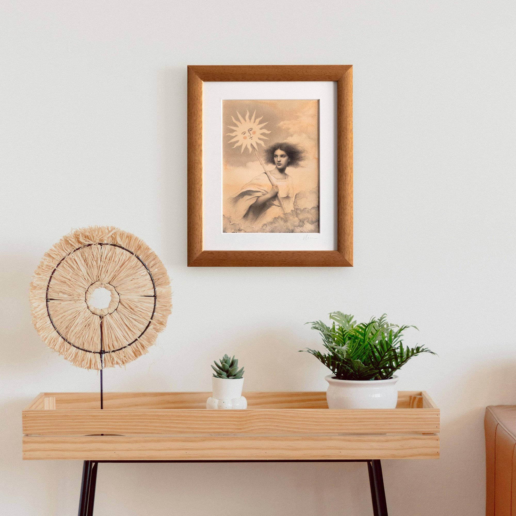 "The Sun Bearer" original drawing by avidoma, framed and displayed on a wall in a bright, modern interior. The shot shows the 20x25 cm wood frame in a home setting