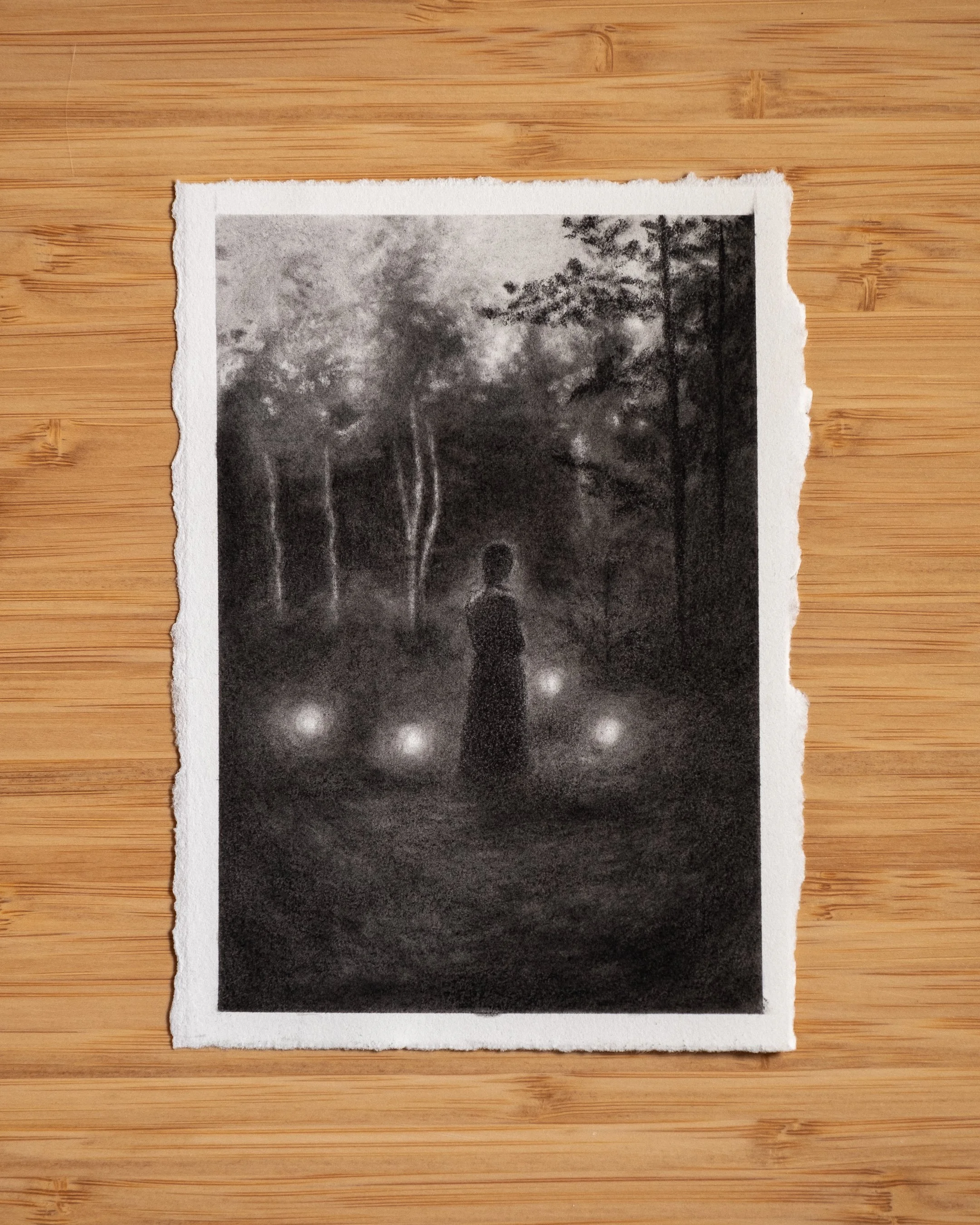 A black-and-white charcoal drawing of a woman standing in a forest at dusk, her back turned, surrounded by glowing orbs.