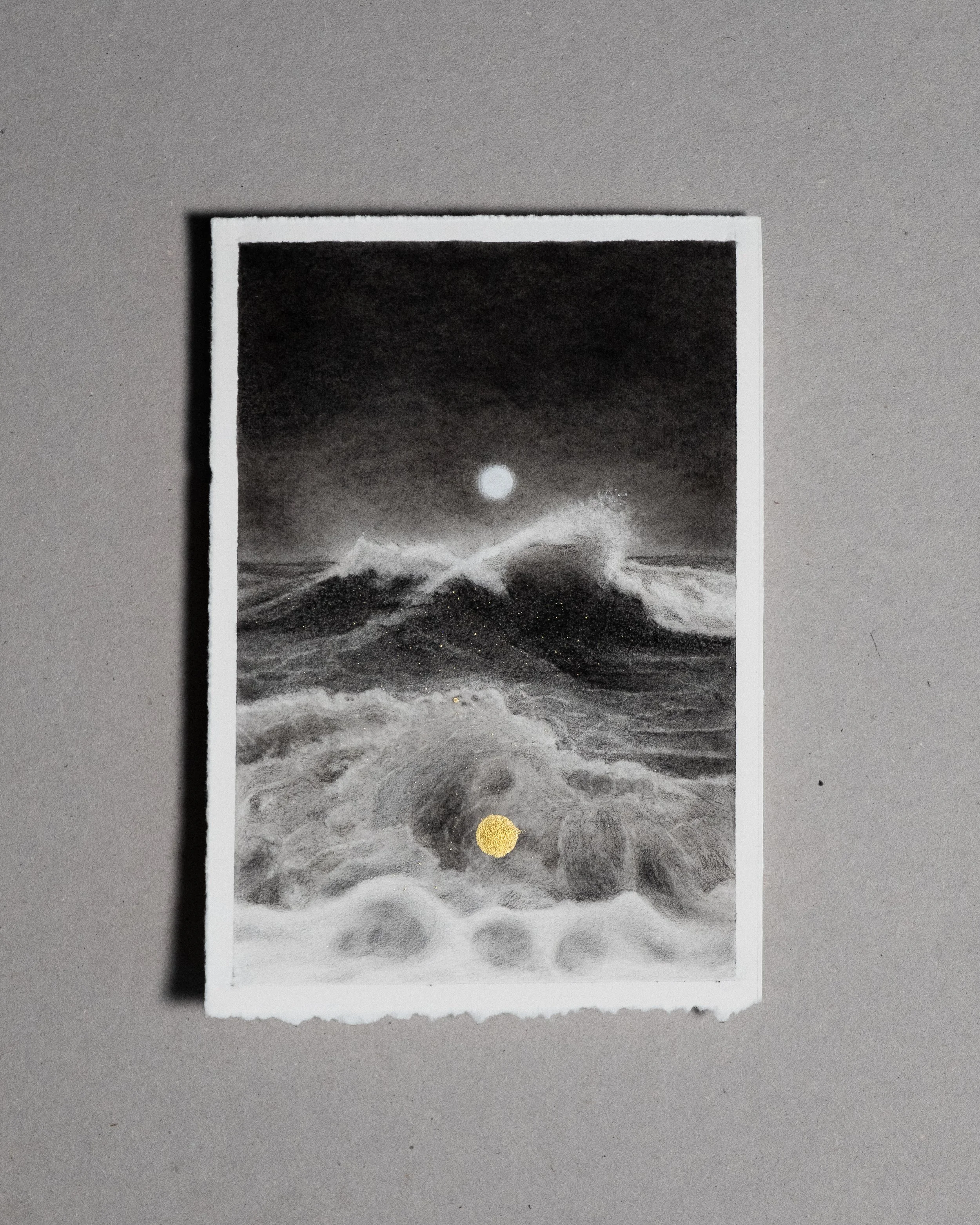 Black and white graphite and charcoal drawing of ocean waves under a bright moon in the night sky with a small gold circle at the bottom.