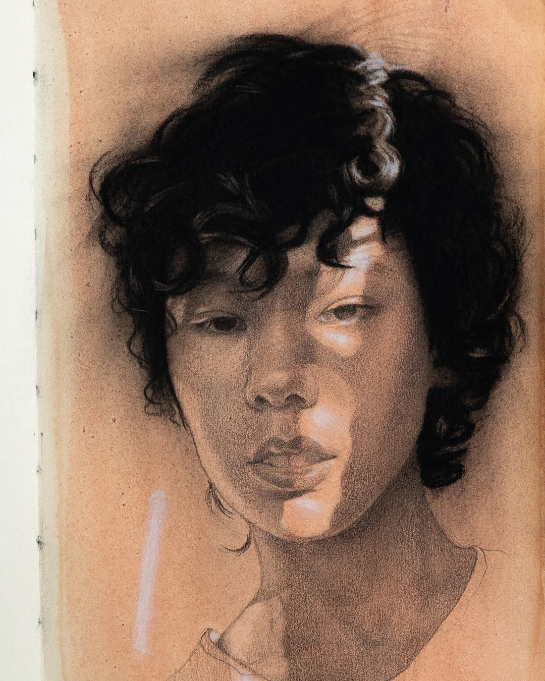 Mixed media, black and white sketch of a woman with short, dark curly hair, looking slightly to the side with a serious expression, on an peach colored background.
