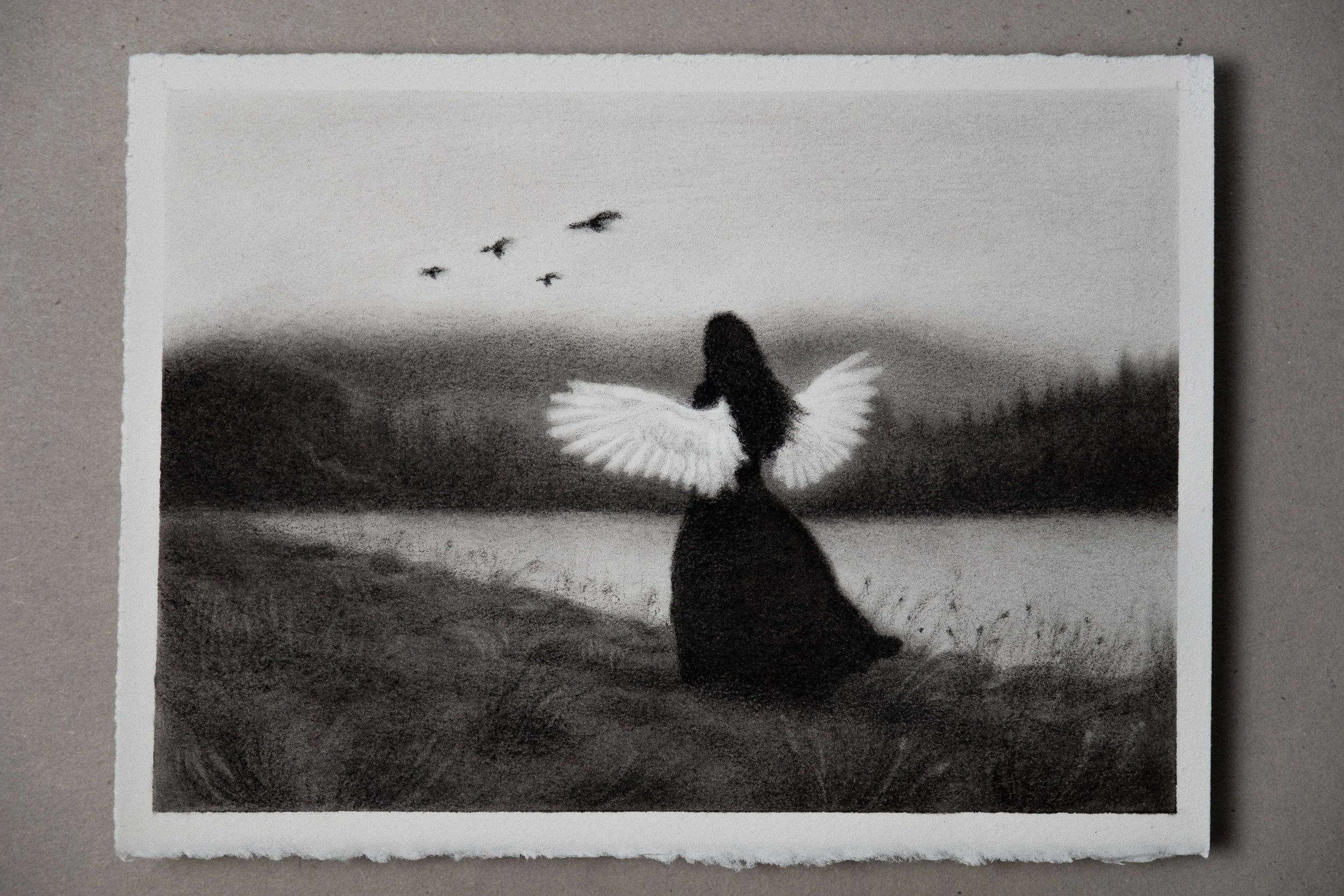 A black and white charcoal and graphite drawing of a woman with wings standing on a grassy lake shore, with birds flying in the background.