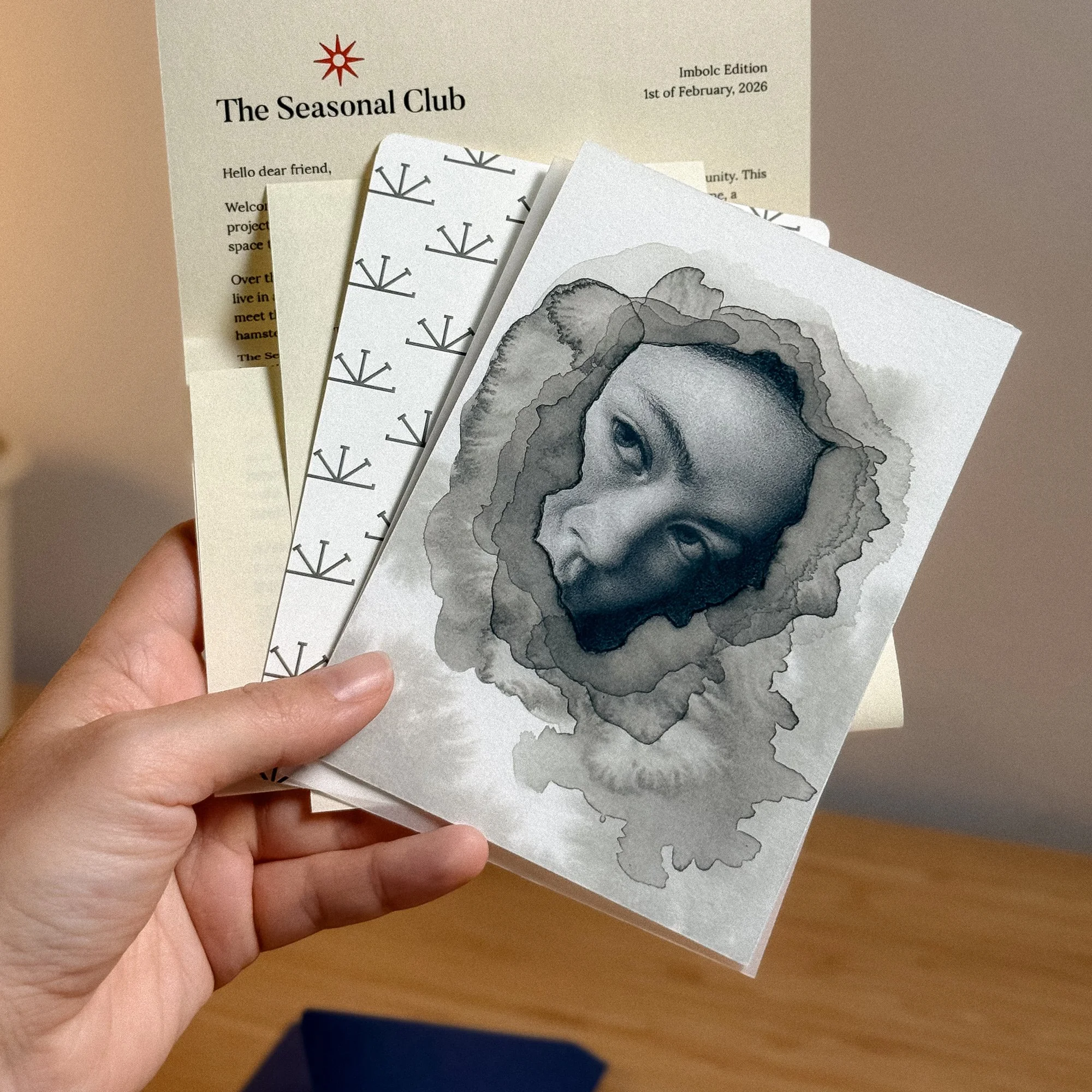 close up of the seasonal club art snail mail, held in hand by the artist