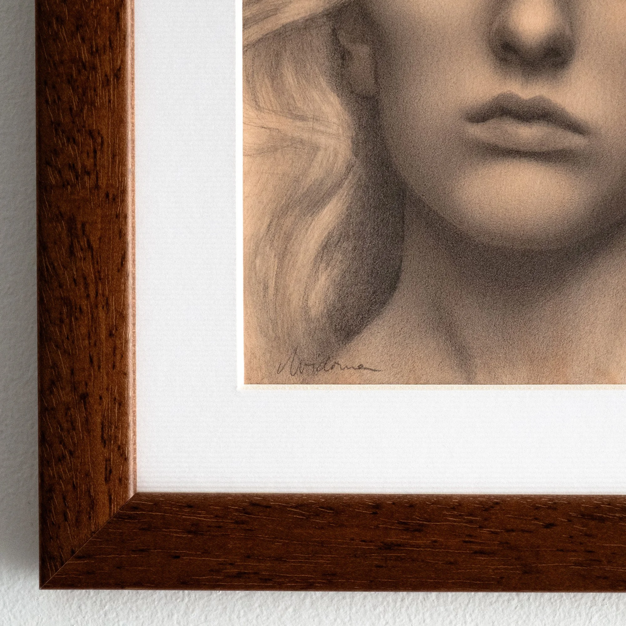 Close-up of an original framed portrait drawing in graphite, showing a woman marked with a golden butterfly, created as unique Summer Solstice-inspired art.