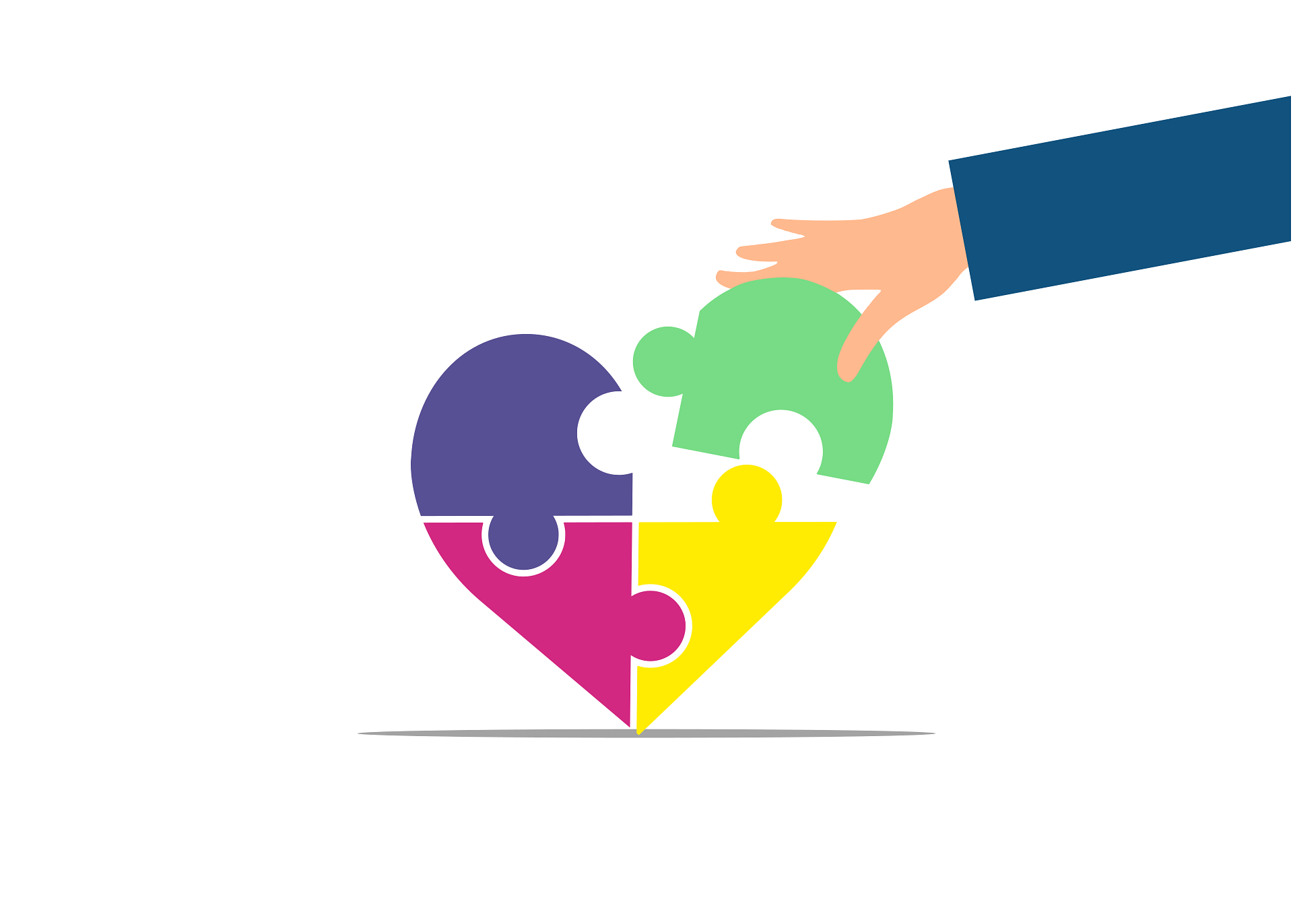 a puzzle in the shap of a heart with four coloured pieces and a heand is putting the fourth piece which is green into place to complet the heart