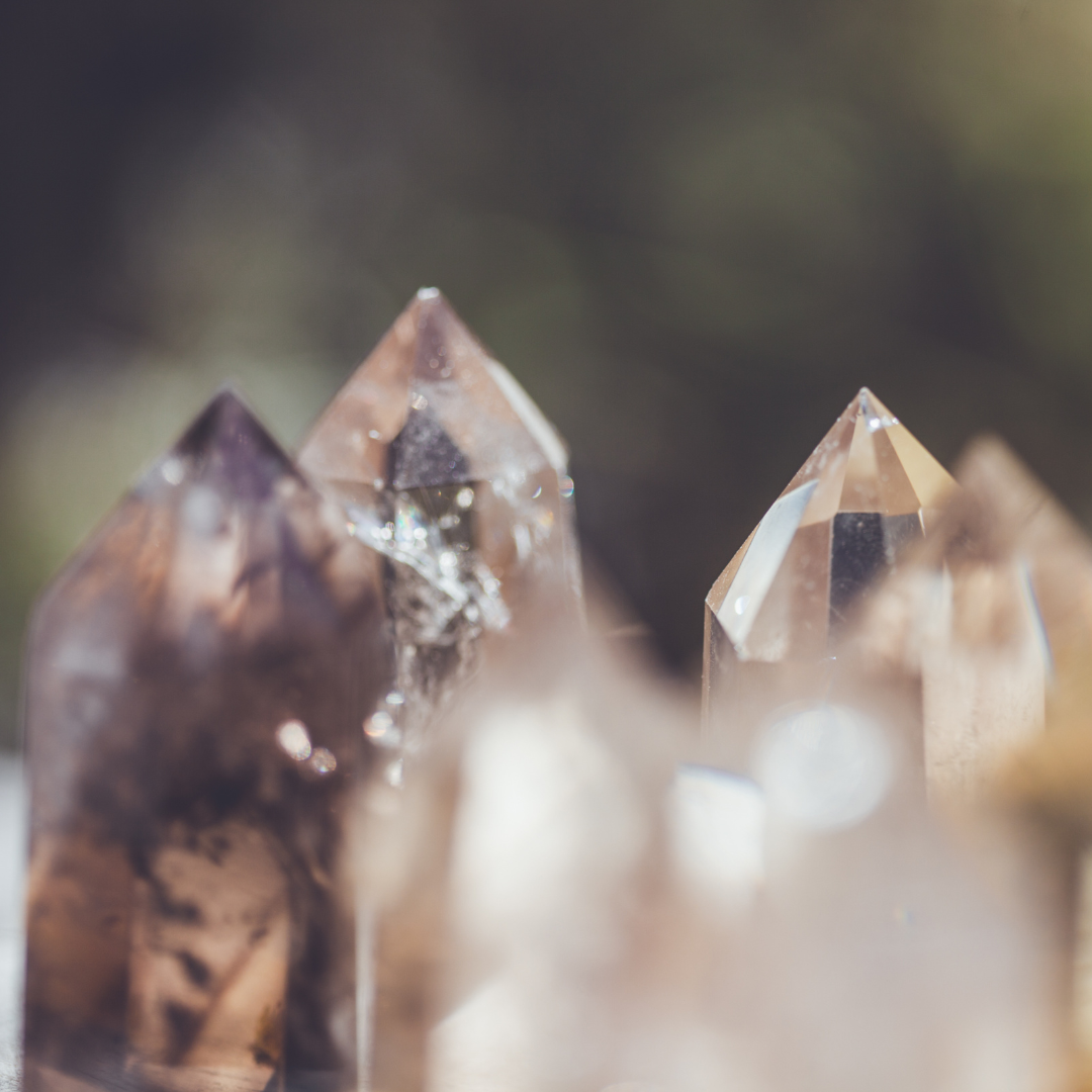 Close-up of several quartz crystals with pointed tips, in natural outdoor light.