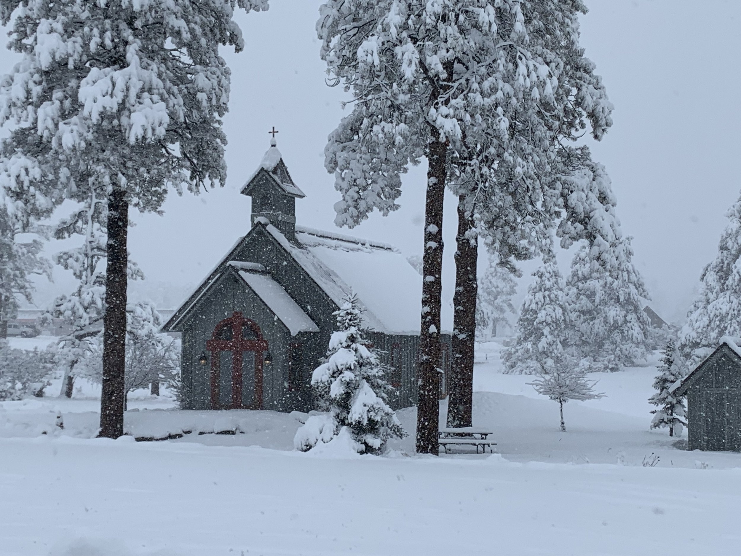 A local Pagosa church being blanketed with snow.