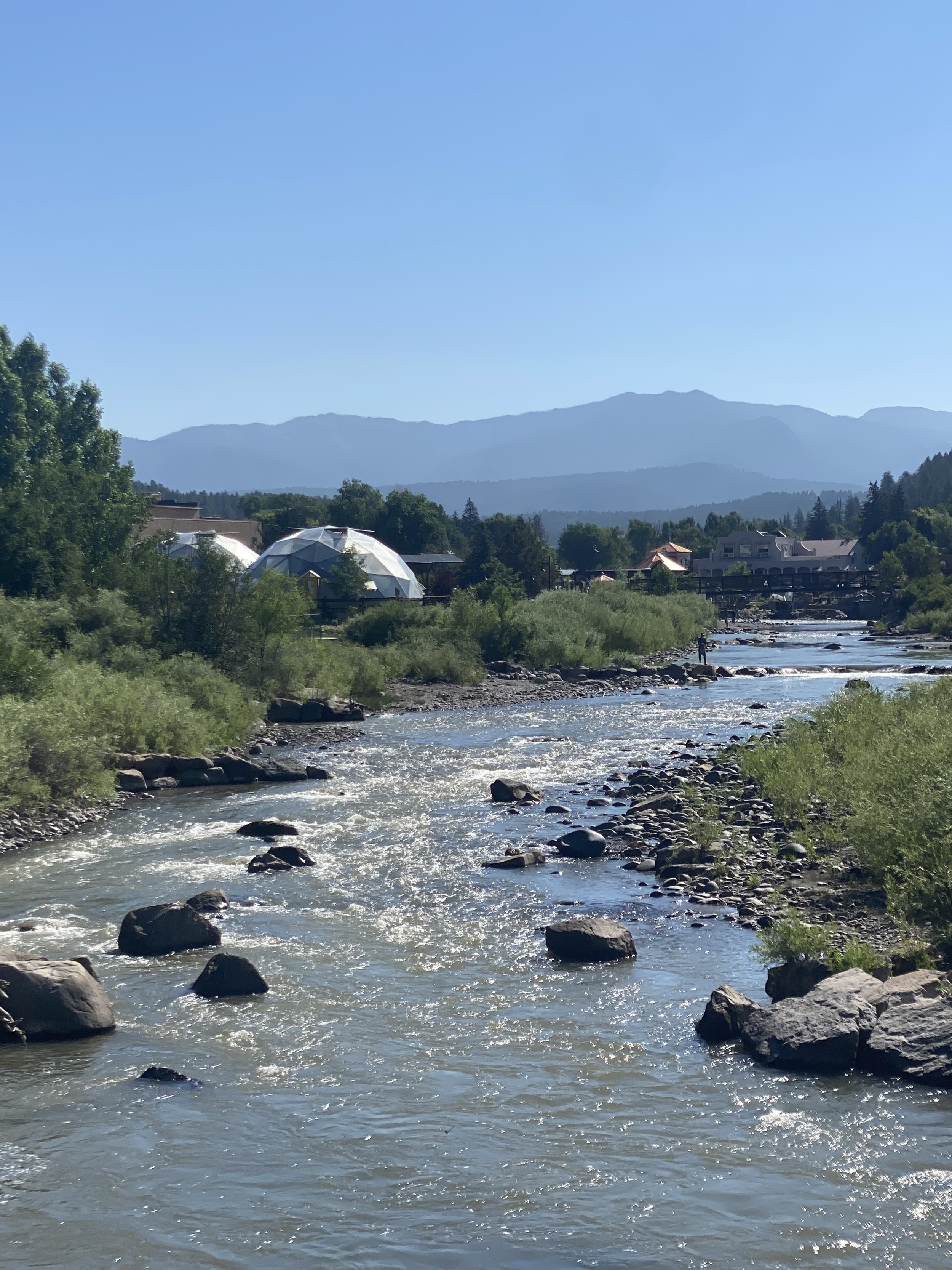 The San Juan River flowing by the community gardens in downtown Pagosa Springs.