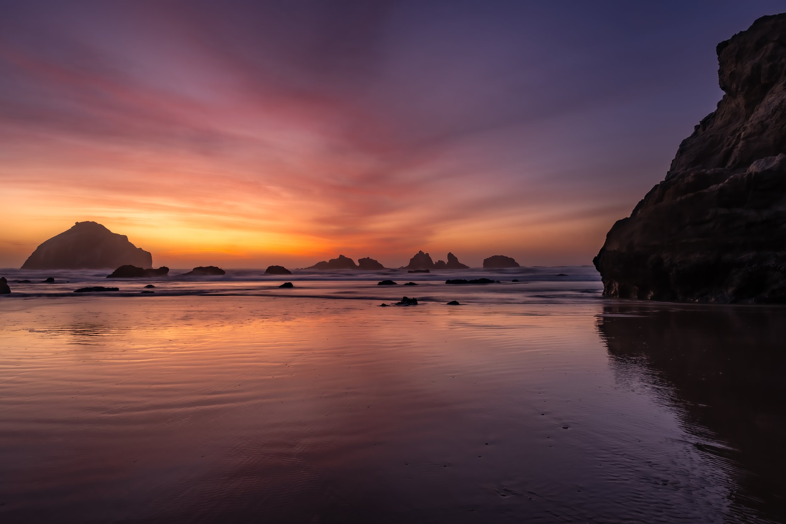 Sunset in full throw on the Pacific Ocean in Bandon, OR.