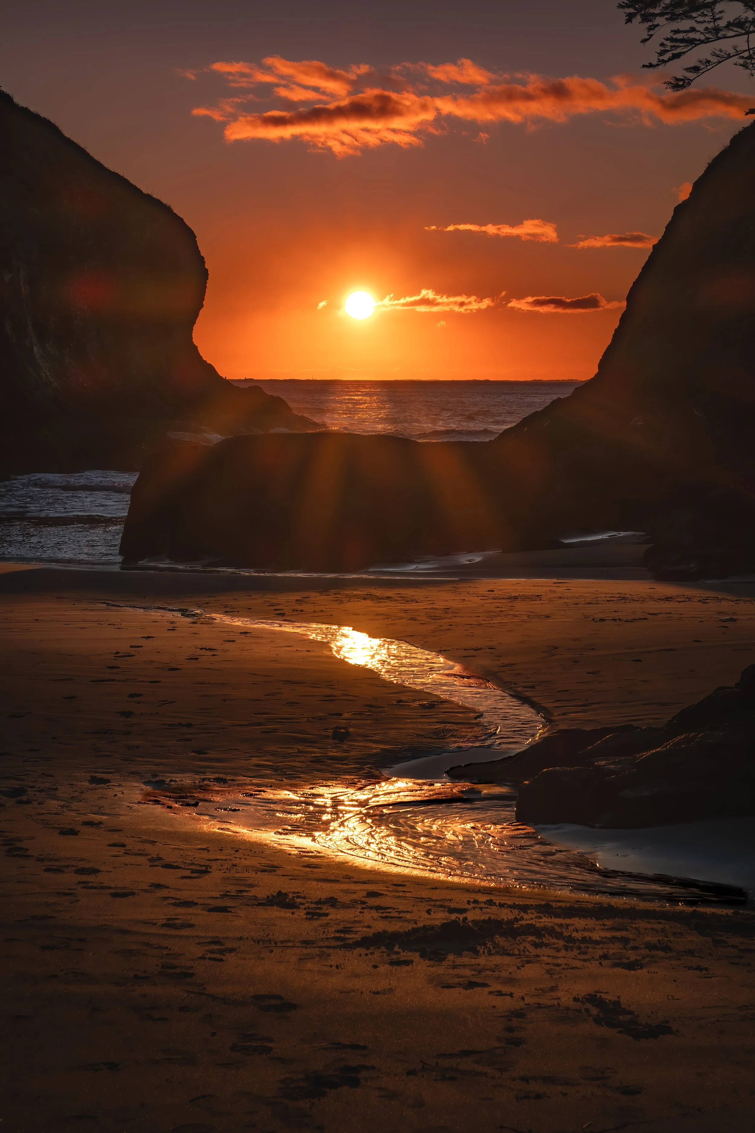 Last rays of sun hitting a small creek entering the Pacific Ocean.