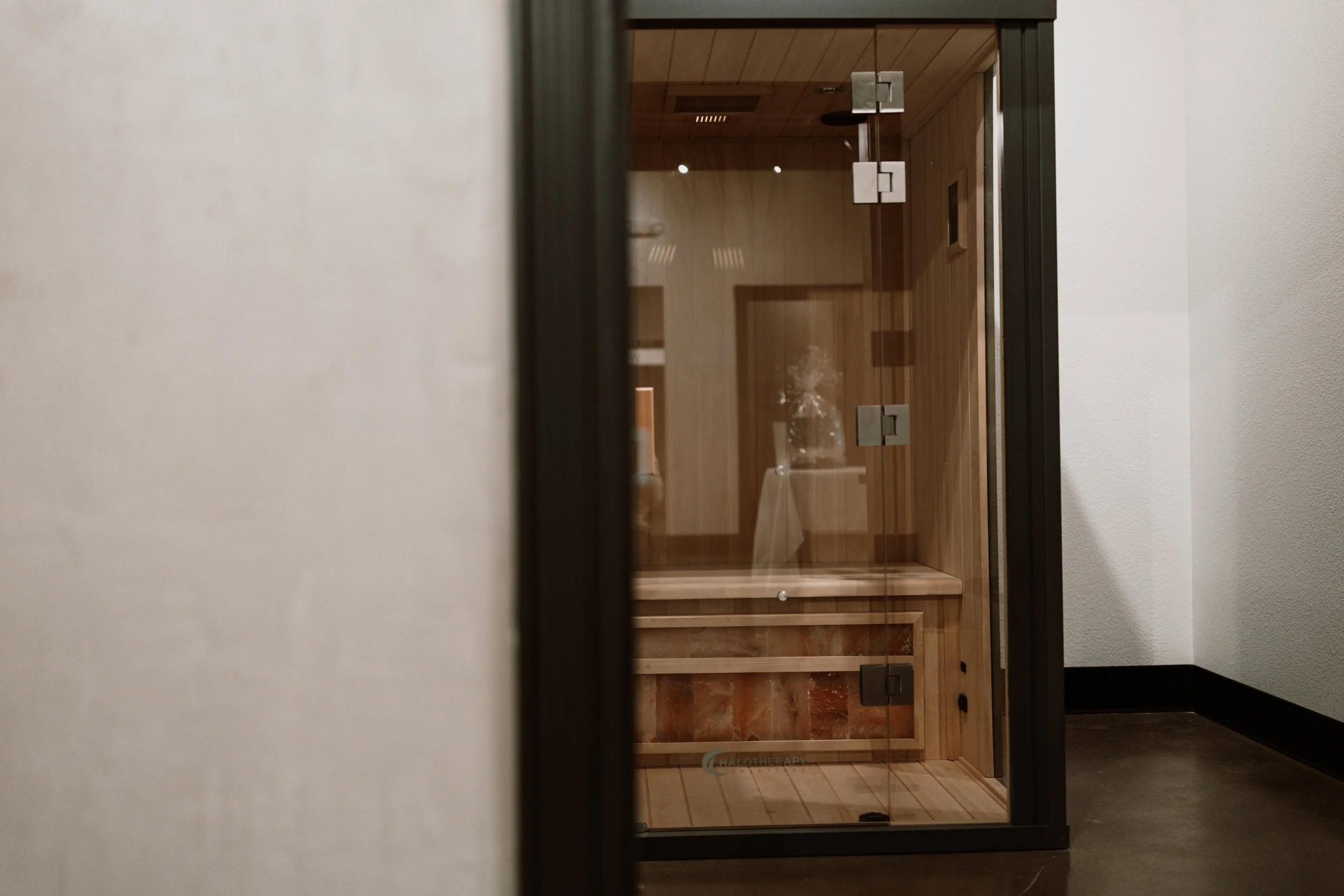 Luxury tented lodge in a desert landscape with rocky hills and sparse vegetation.