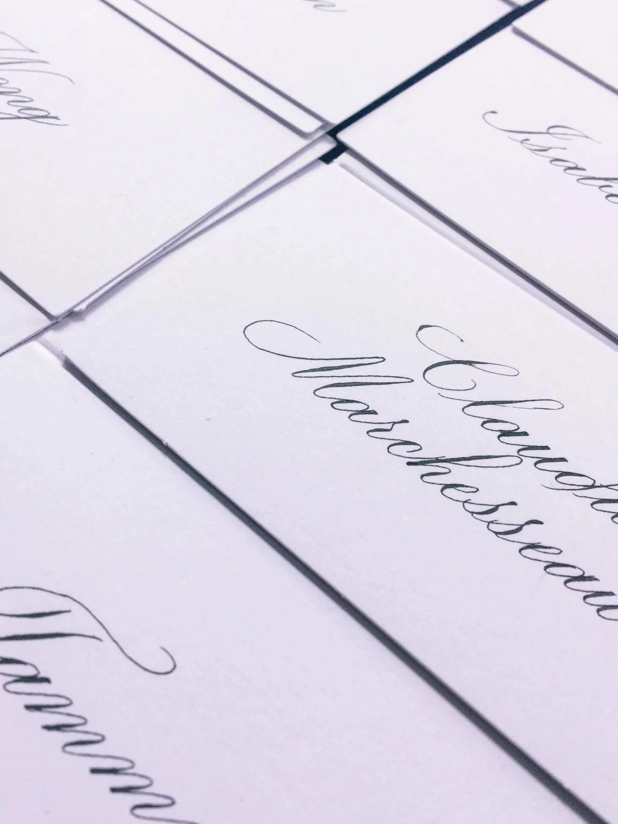 White cards with black cursive text that reads 'Class Photo Memories' arranged on a flat surface.