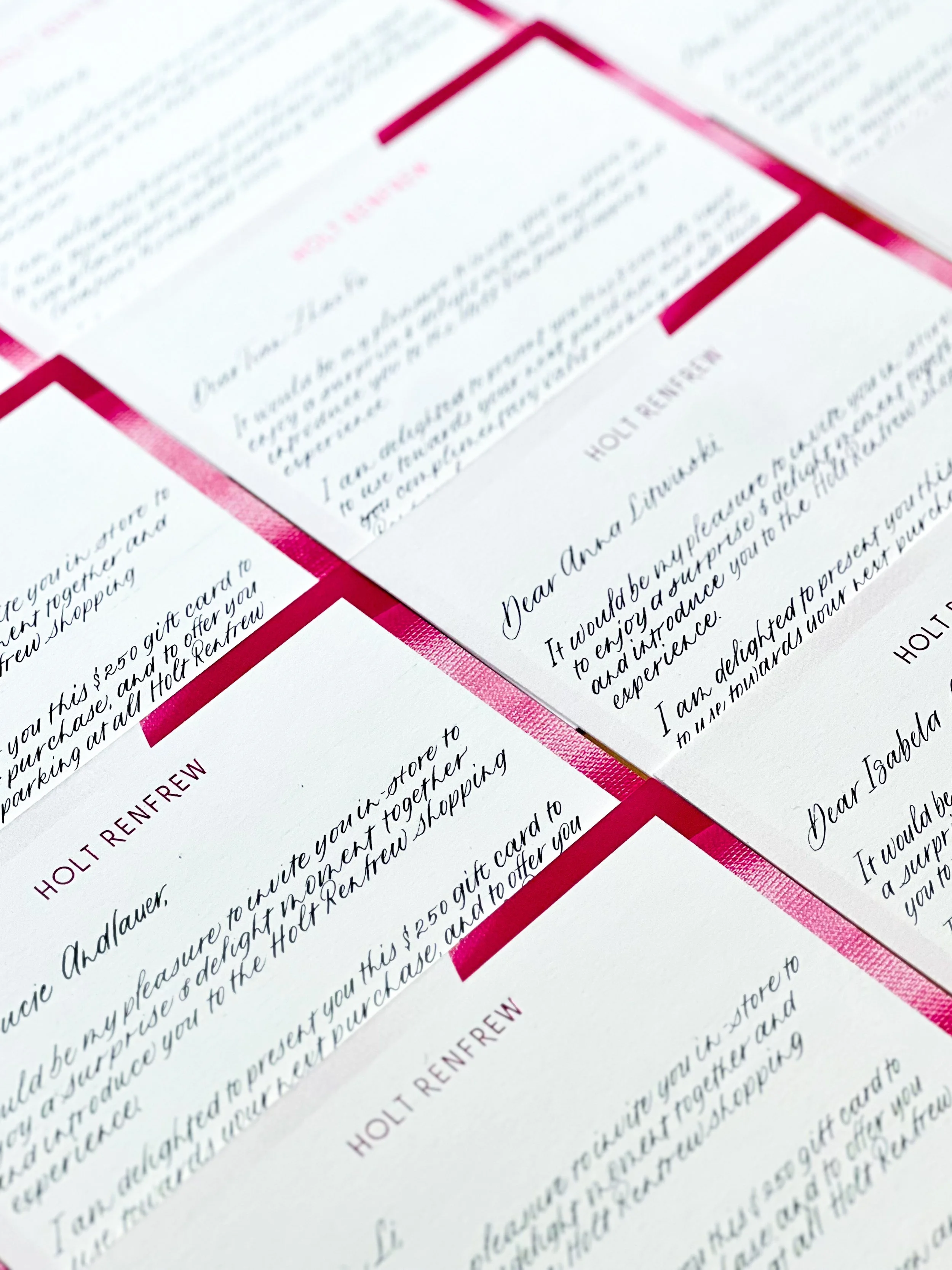 Close-up of handwritten note cards on white paper with red accents, arranged in a grid pattern.