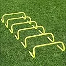Six yellow hurdles arranged in a row on a grassy field.