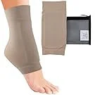 A person wearing a beige compression sock on their foot and ankle, with additional beige compression sleeves and a box of compression stockings in the background.