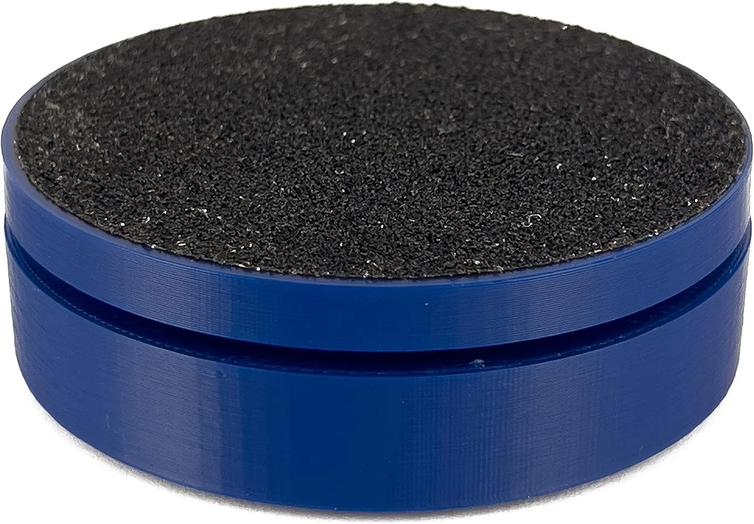 A small round container with a blue plastic body and a black, textured, foam-like interior surface.