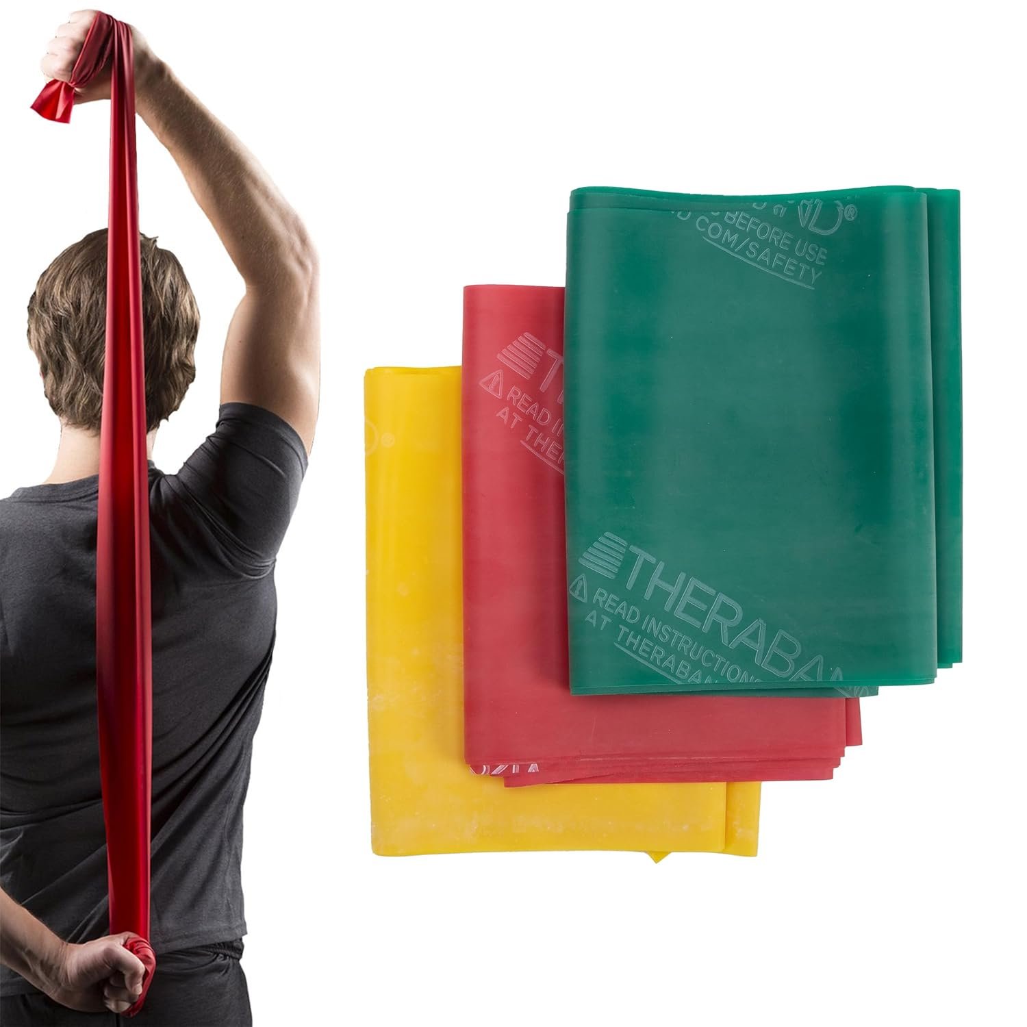 A person holding a red resistance band with a stack of three colorful therapy or exercise bands (yellow, red, green) beside them.