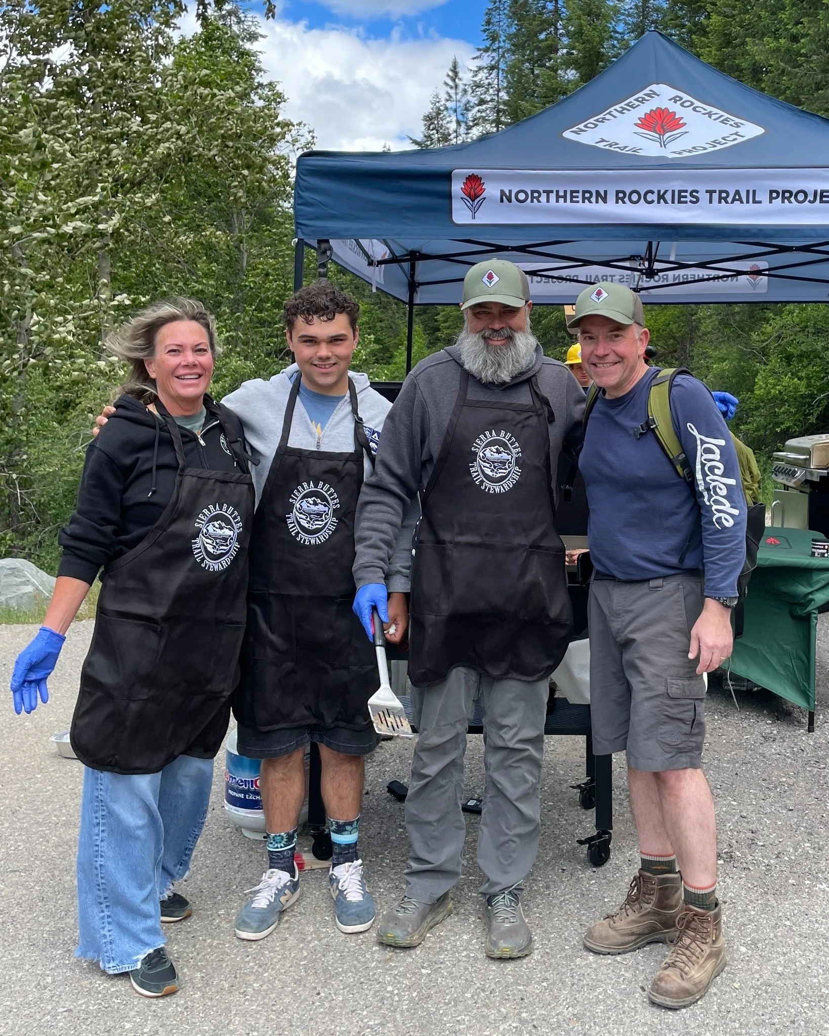 Sierra Buttes Trail Stewardship executive director Greg Williams spent National Trails Day as the Barbecue Wizard for a National Forest trail day, alongside U.S. Forest Service Chief Tom Schultz, far right, and 85 volunteers representing all kinds of