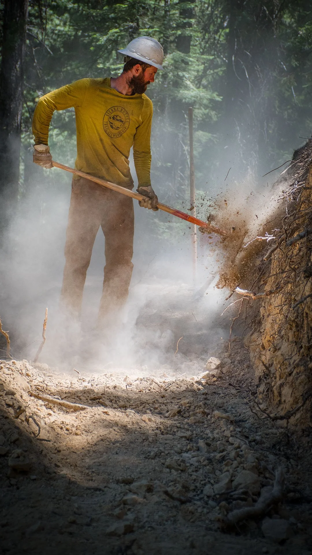 Trail crew member digging trail