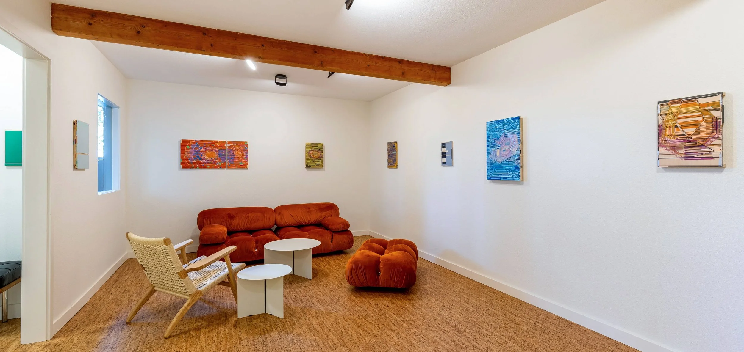 Sofas, chairs and tables with painting on display in RecRoom, a contemporary art gallery in Eugene.