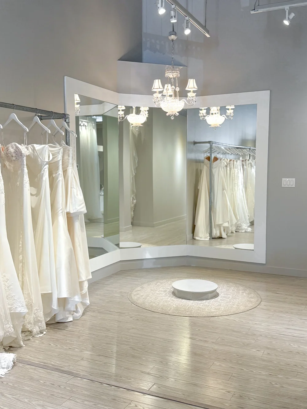Inside the With Love Bridal boutique, with a fitting pedestal and mirrors