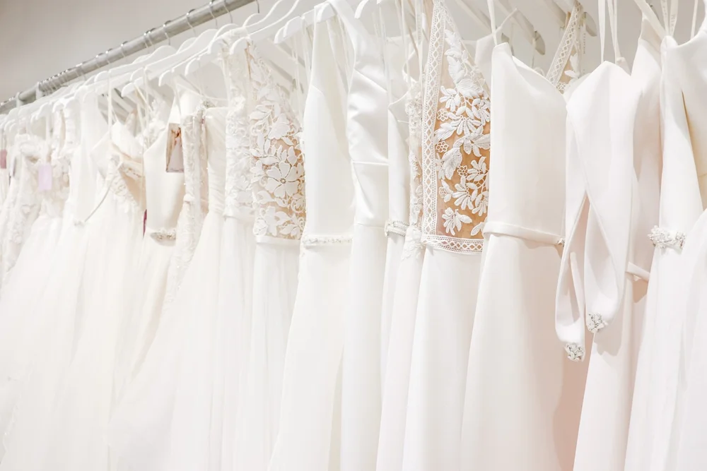 A rack of white wedding gowns