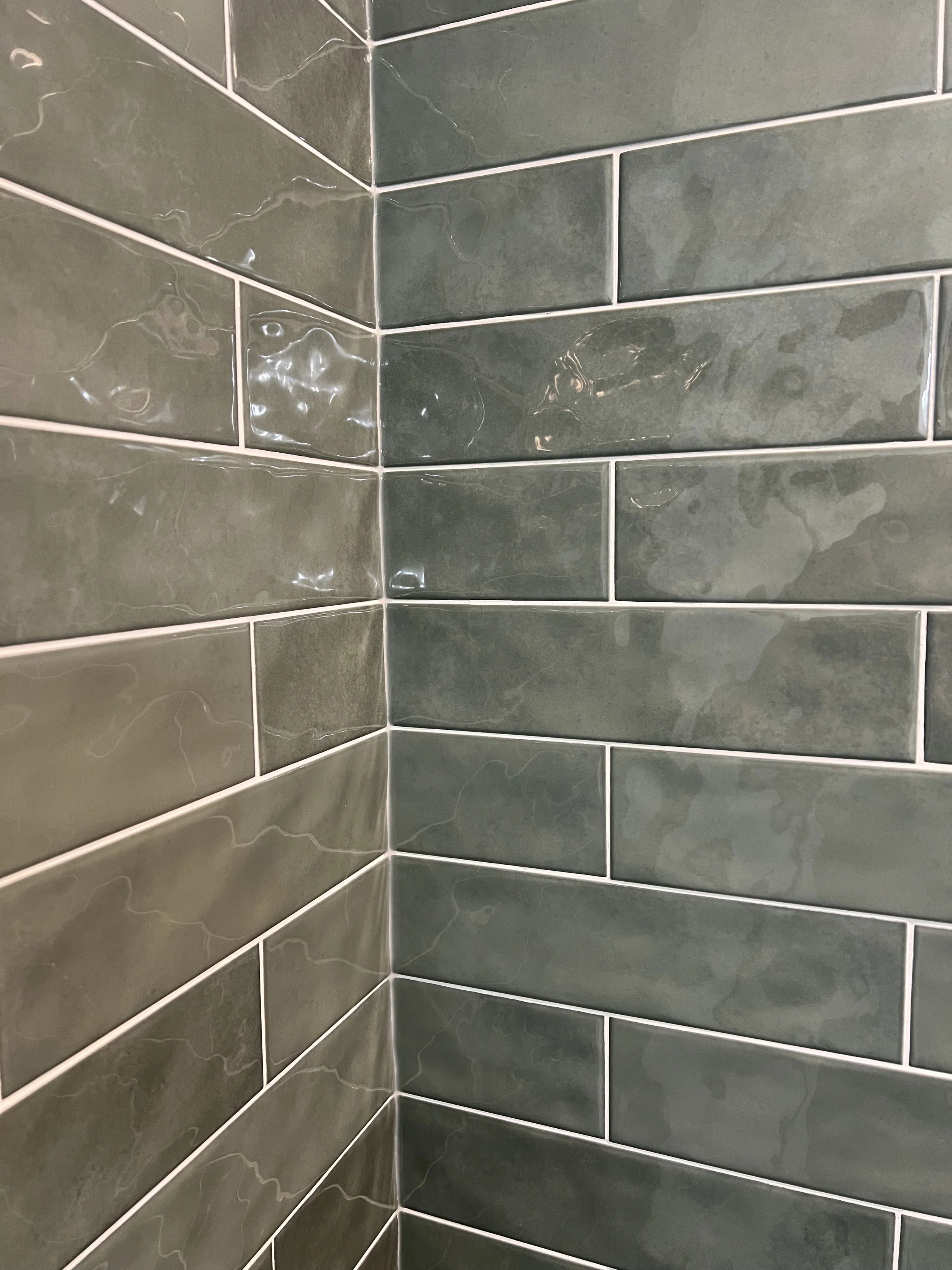 Green subway tiles on a wall corner