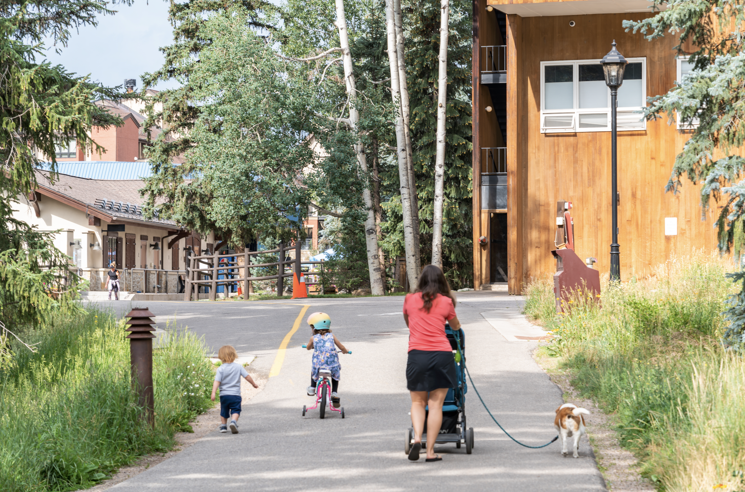 Mom and two children walk on the Gore Creek Trail between Lionshead and Vail Village.